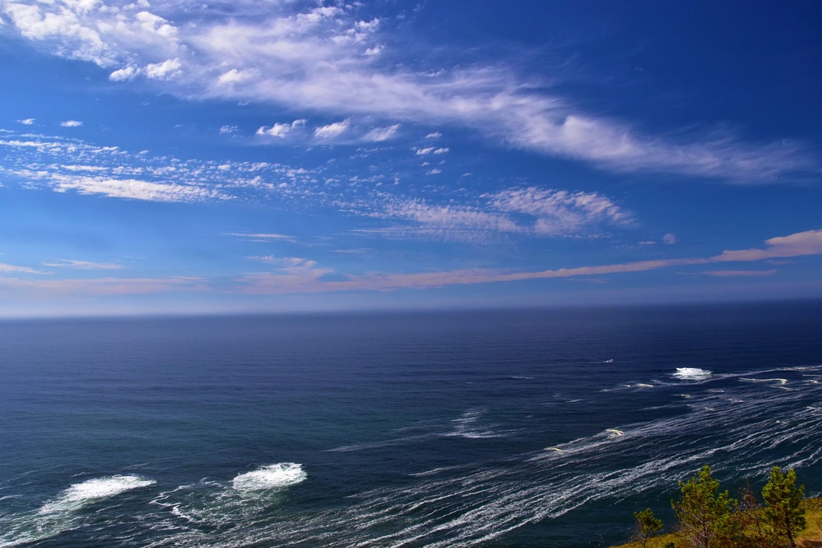 Breathtaking view of the ocean under a bright blue sky, ideal for serene stock imagery.