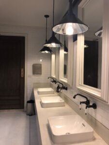 Stylish bathroom interior showcasing sinks, mirrors, and pendant lights for a contemporary look.