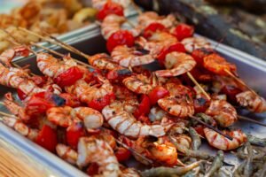 Delicious grilled shrimp skewers with roasted vegetables, perfect for a summer barbecue.
