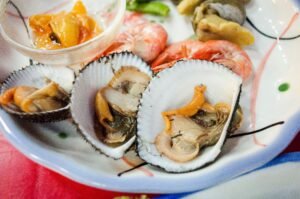 Close-up of a seafood platter featuring fresh oysters, shrimp, and shellfish. Perfect for gourmet cuisine lovers.